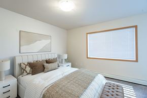 Moorhead apartment for rent - A bedroom with a large bed and a painting on the wall. Moorhead, MN Sandy Creek Apartments