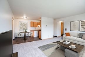 West Fargo apartment for rent - A living room with a couch, coffee table, and television. West Fargo, ND Saddlebrook Apartments