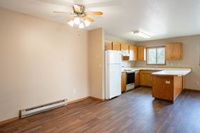 Fargo apartment for rent - A kitchen with wooden floors and a ceiling fan.