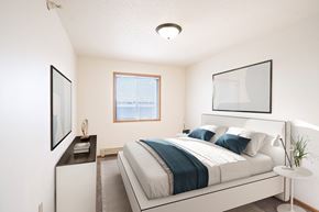 Dilworth apartment for rent - A bedroom with a large bed and a window. Fargo, ND Fieldstone Apartments