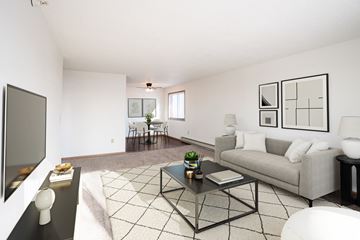Dilworth apartment for rent - A living room with a grey couch, a black coffee table, and a television on the left side.