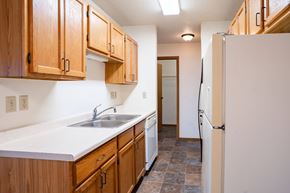 Fargo apartment for rent - A kitchen with wooden cabinets and a white sink. Fargo, ND Southgate Apartments