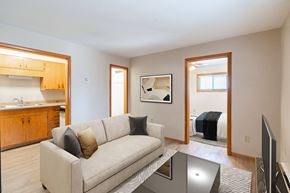 Fargo apartment for rent - A living room with a couch, a coffee table, and a television. Fargo, ND Birchwood Apartments