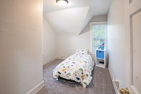 Fargo apartment for rent - A bedroom with a bed, nightstand, and window. Fargo, ND Marlowe South Apartments