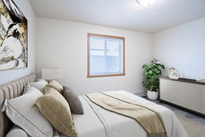 Moorhead apartment for rent - A bedroom with a large bed and a window. Moorhead, MN Woodstone Apartments