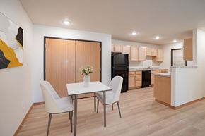 Grand Forks apartment for rent - A modern kitchen with a dining table and chairs. Grand Forks, ND Cherry Creek Apartments