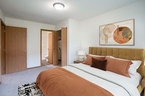 Grand Forks apartment for rent - A bedroom with a large bed and a painting on the wall. Grand Forks, ND Columbia West Apartments