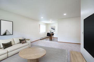 Grand Forks apartment for rent - A living room with a white couch and a wooden coffee table.