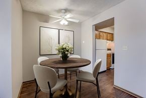 Omaha townhouse for rent - A dining room with a round table and chairs. Omaha, NE Stony Brook Apartments