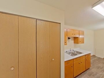 Crookston apartment for rent - A kitchen with wooden cabinets and a sink.