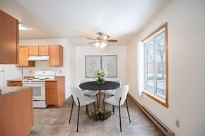 Fargo apartment for rent - A kitchen with a table and chairs in the middle of the room. Fargo, ND Long Island Apartments