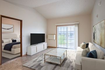 Fargo apartment for rent - A living room with a white couch and a black television.
