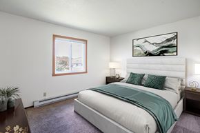 Fargo apartment for rent - A bedroom with a large bed and a painting on the wall. Fargo, ND Summerfield Apartments
