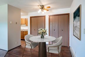 Fargo apartment for rent - A dining room with a round table and chairs. Fargo, ND Summerfield Apartments