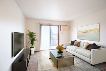 Fargo apartment for rent - A living room with a white couch, a flat screen TV, a coffee table, and a painting on the wall.