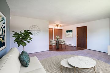 Fargo apartment for rent - A living room with a white couch and a round coffee table.