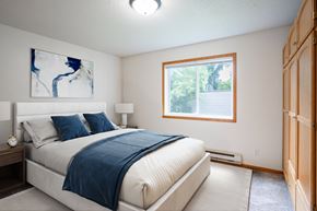 Fargo apartment for rent - A bedroom with a large bed and a window. Fargo, ND Crown Court Apartments
