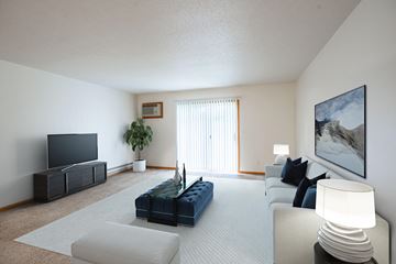 Fargo apartment for rent - A living room with a blue couch and a television.