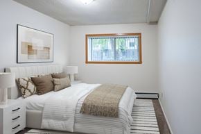 Fargo apartment for rent - A bedroom with a large bed and a window. Fargo, ND Park Terrace Apartments