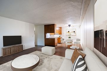 Fargo apartment for rent - A modern living room with a white couch and a television.