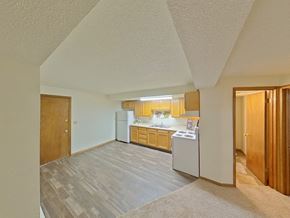 Grand Forks apartment for rent - A kitchen with a white fridge and a white washing machine.