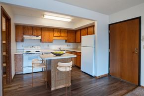 West Fargo apartment for rent - A kitchen with wooden cabinets and a white fridge. West Fargo, ND Clearview Apartments