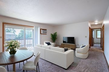 West Fargo apartment for rent - A living room with a white couch and a television.