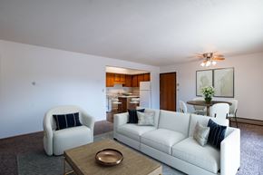 West Fargo apartment for rent - A living room with a white couch, a chair, and a coffee table. West Fargo, ND Clearview Apartments