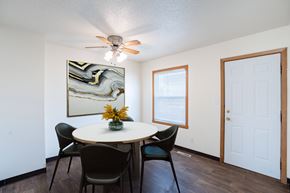 West Fargo townhouse for rent - A dining room with a round table and chairs. West Fargo, ND Sheyenne Terrace Townhomes