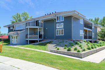 Grand Forks apartment for rent - a blue house with a sidewalk and lawn in front of it