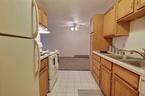 Fargo apartment for rent - a kitchen with a stove refrigerator and sink. Fargo, ND Alden Pines Apartments