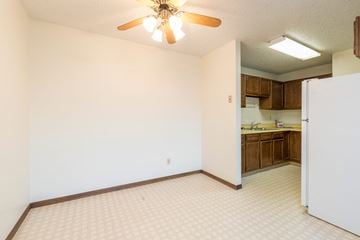 Bismarck apartment for rent - a kitchen with a refrigerator and a ceiling fan