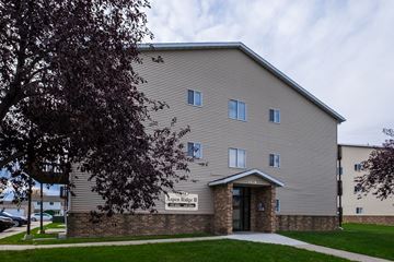 Fargo apartment for rent - the side of a building with a sidewalk and a tree