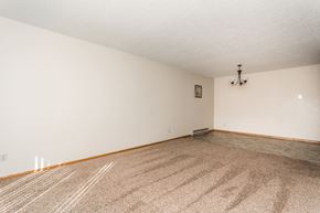 Crookston apartment for rent - Grand Forks, ND Barrette Arms Apartments.  a living room with white walls and a beige carpet