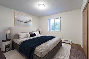 Bismarck apartment for rent - a bedroom with a bed and a window. Bismarck, ND Belmont East Apartments