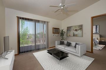 Fargo apartment for rent - a living room with a couch and a coffee table and a ceiling fan