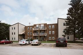 Grand Forks apartment for rent - Grand Forks, ND Bristol Park Apartments.  A brick apartment building with cars parked in front of it