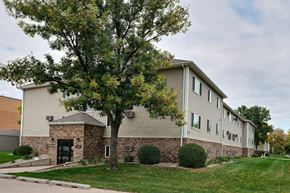 Fargo apartment for rent - an apartment building with a tree in front of it. Fargo, ND Brownstone Apartments