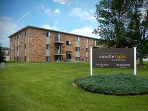 Fargo apartment for rent - a large brick building with a sign in front of it. Fargo, ND Candlelight Apartments