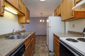 Fargo apartment for rent - a kitchen with a stove sink and refrigerator. Fargo, ND Carlton Place Apartments