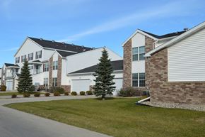 West Fargo townhouse for rent - A row of Fargo, ND Charleswood Townhomes on the side of a street