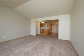West Fargo townhouse for rent - A spacious living room with carpet and a kitchen
