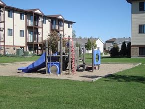 Fargo apartment for rent - a playground in front of an apartment building. Fargo, ND Chestnut Ridge Apartments