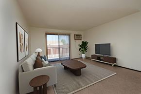 Fargo apartment for rent - the living room of an apartment with a couch and a tv. Fargo, ND Countryside Apartments