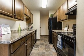 Bismarck apartment for rent - Bismarck, ND Eagle Sky I Apartments. A kitchen with black appliances