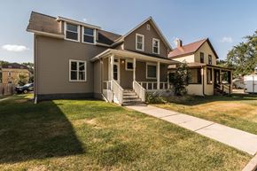 Grand Forks apartment for rent - Grand Forks, ND Faul 4 Plex. A home with a green lawn and a brown house in the background