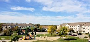 Hutchinson apartment for rent - a park with a playground and apartment buildings in the background