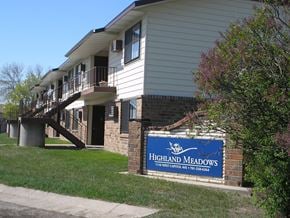 Bismarck apartment for rent - The exterior of a two level apartment building at Highland Meadows in Bismarck, ND