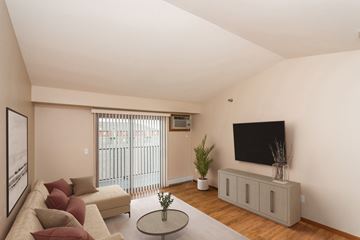 Grand Forks apartment for rent - Grand Forks, ND Sterling Pointe Apartments. a living room with a couch and a tv on the wall