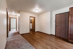 Grand Forks apartment for rent - Grand Forks, ND Grandview II Apartments. A dining room with a hallway to the bedrooms and the main entry door with a laundry closet next to it.